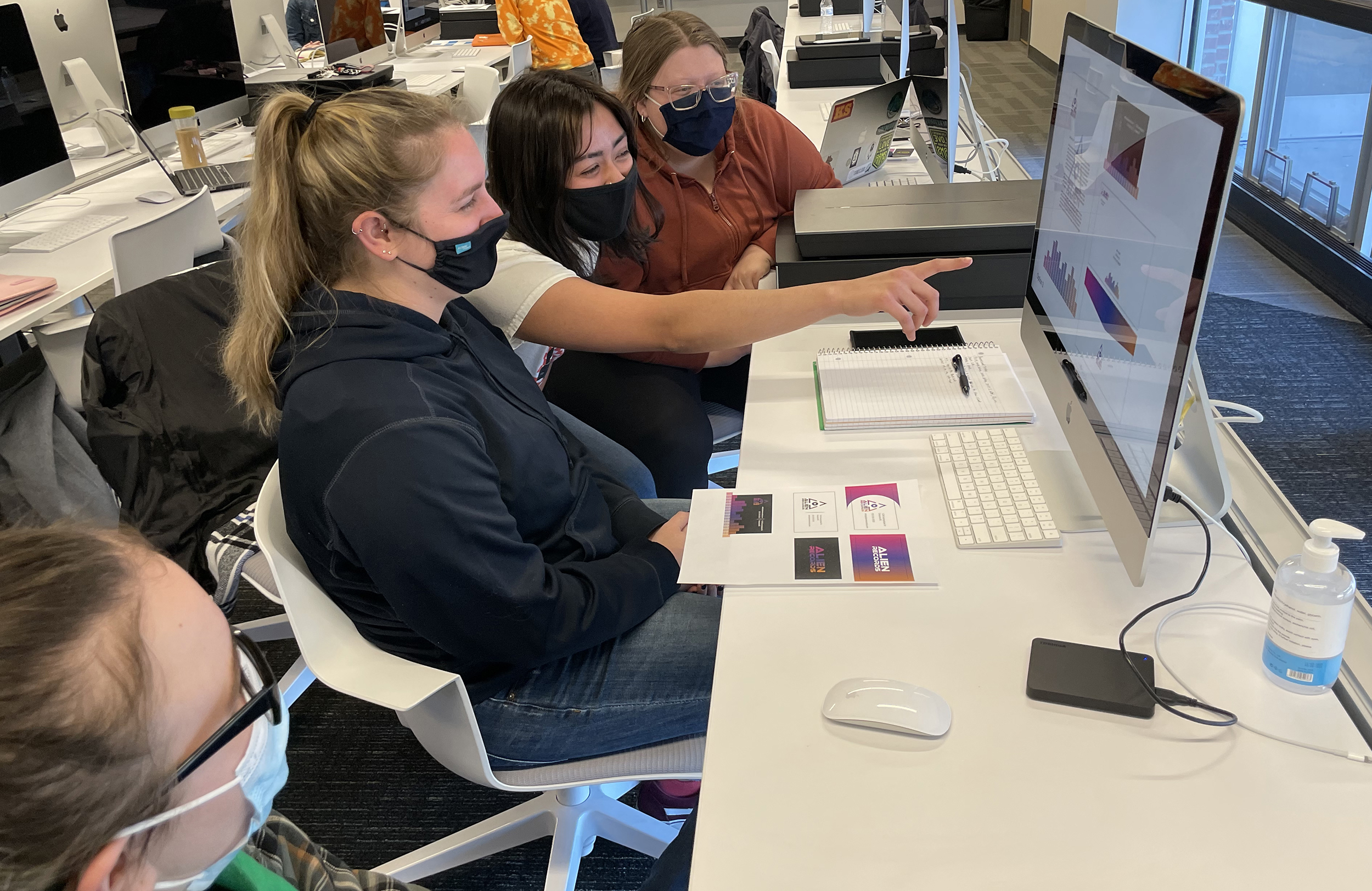 A group of people working on a design together