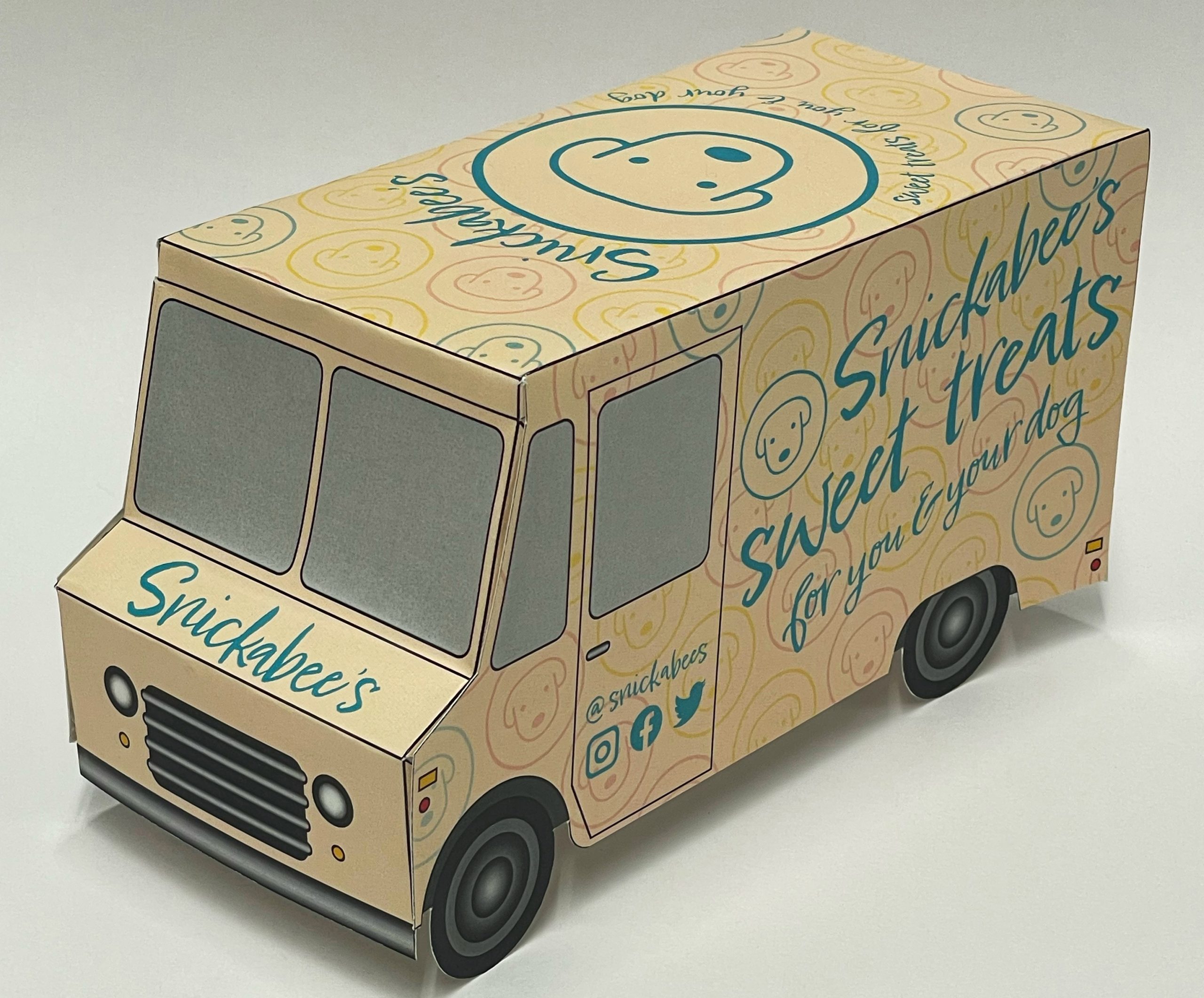 A tan paper food truck with the Snickabees Sweet Treats logo around it.